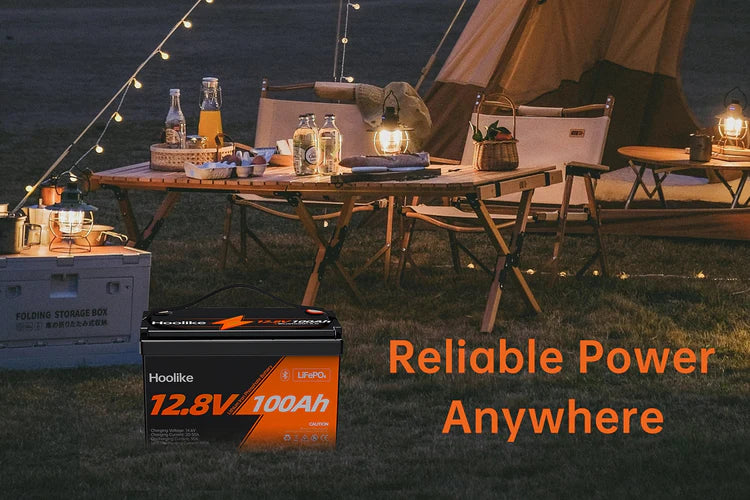 "Hoolike 12.8V 100Ah LiFePO4 battery powering outdoor camping setup"