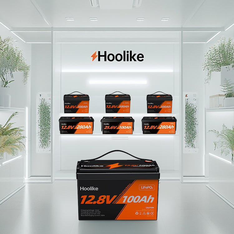  Hoolike LiFePO4 12.8V 100Ah battery displayed in a modern showroom with other battery models on shelves