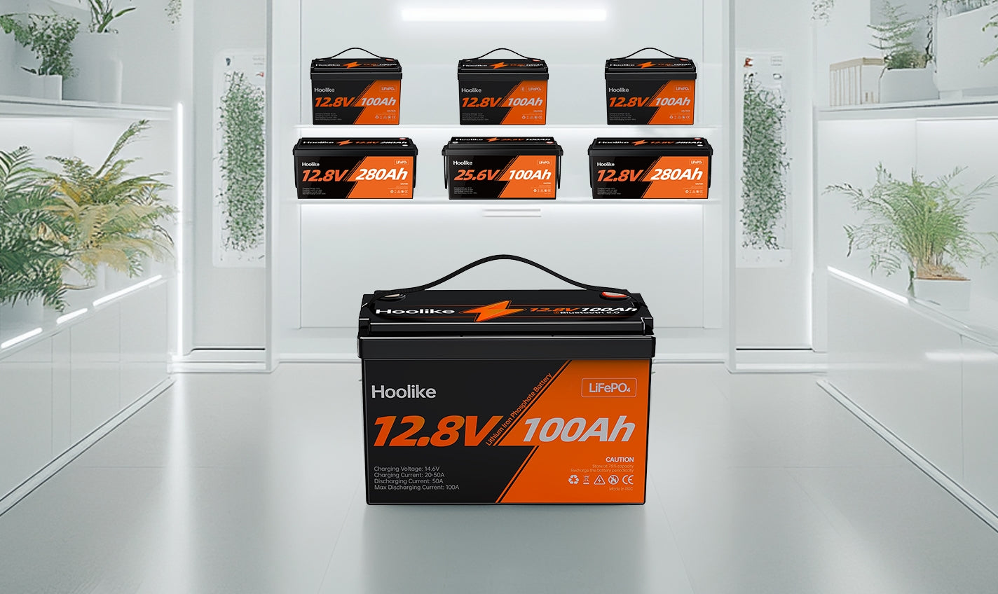 A display of Hoolike LiFePO4 batteries, featuring a prominent 12.8V 100Ah model in the foreground, surrounded by other battery units in a sleek, modern showroom with greenery accents