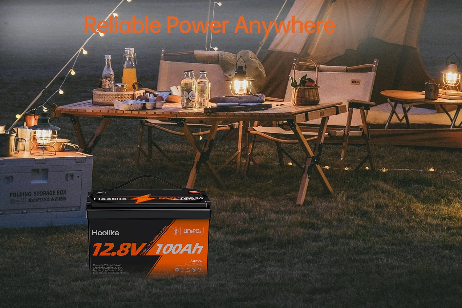 Hoolike 12.8V 100Ah LiFePO4 battery featured in a nighttime camping setup with string lights, a tent, and an outdoor dining area.