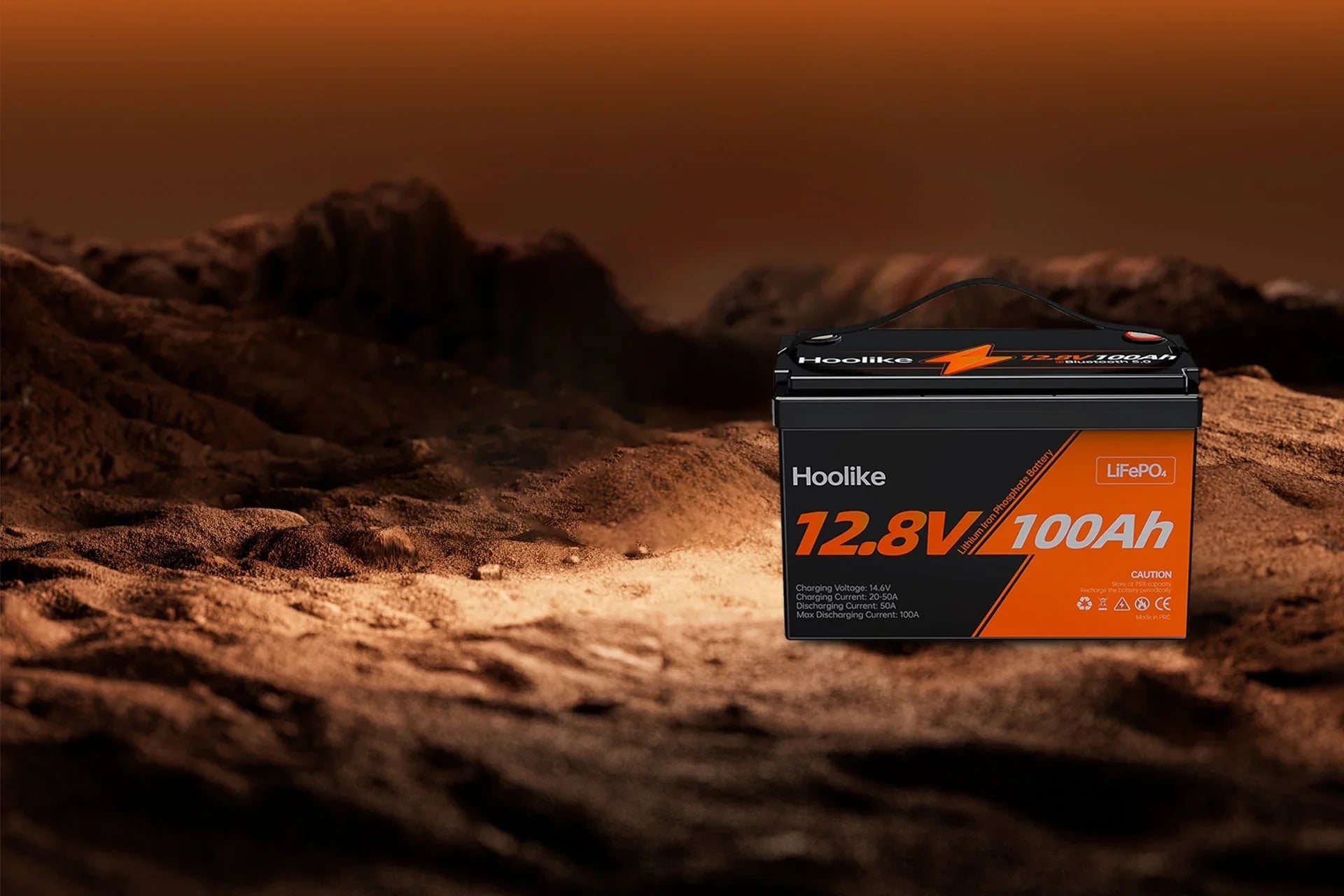 Hoolike 12.8V 100Ah LiFePO4 battery on rugged terrain, durable power for outdoor use