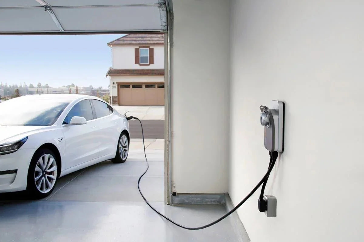 White electric car charging at home garage with wall-mounted EV charger